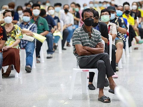 People queue at the Central Vaccination Centre as Thailand opens walk-in for first dose of the AstraZeneca vaccination scheme for elders, people with a minimum weight of 100 kilograms and pregnant women amid the coronavirus (COVID-19) outbreak in Bangkok, Thailand, July 26, 2021. 