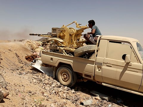 A Yemeni government fighter fires a vehicle-mounted weapon at a frontline position during fighting against Al Houthi militants in Marib in a file photo.