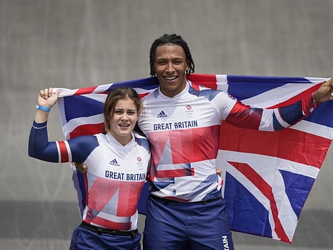 Bethany Shriever of Britain (left) who won gold in the women's, and Kye Whyte of Britain, who won silver in the men's, celebrate their wins in the BMX Racing finals at the 2020 Summer Olympics.