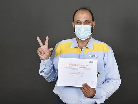  A Dubai taxi driver with his certificate after successful completion of the Dubai Way training programme.