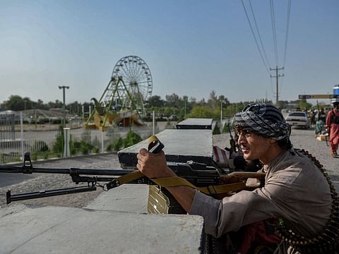 Afghan security personnel and Afghan militia fighting against Taliban, stand guard in Enjil district of Herat province on July 30, 2021. 