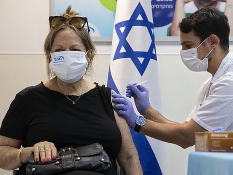 An Israeli woman receives a third Pfizer-BioNTech COVID-19 vaccine in the Israeli city of Ramat HaSharon, on July 30, 2021.  