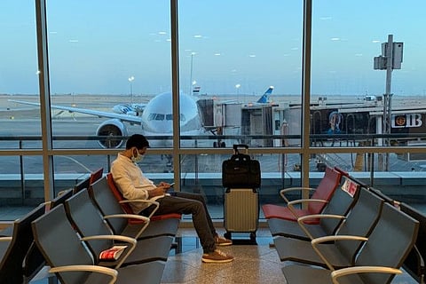 A passenger waits for his flight departure by Qatar Airways to Doha at Cairo's International Airport in Cairo on June 20, 2021. The national Egyptian and Qatari airlines also restarted flights between the two countries in a sign of a thaw in ties.