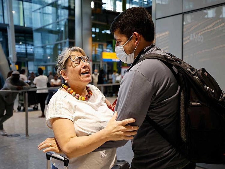 Heathrow arrival mother son airport England covid