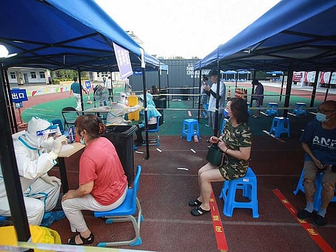 This photo taken on August 1, 2021 shows residents queueing to receive nucleic acid tests for the COVID-19 in Yangzhou in China's eastern Jiangsu province, amid the country's most widespread coronavirus outbreak in months. 