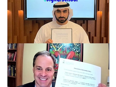 Dr Waleed Al Ali (top), secretary-general, Digital School; and Anthony Bloome, founder of the mEducation Alliance signing the deal 