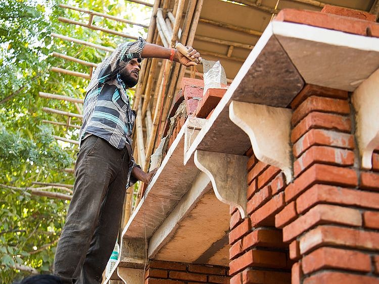 Man building house bricks
