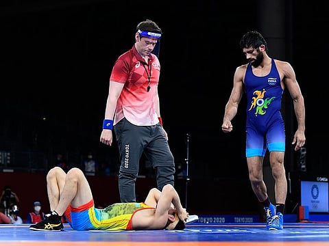 Nurislam Sanayev of Kazakhstan is sprawled on the mat after losing his semi-final bout against Ravi Kumar Dahiya of India. 