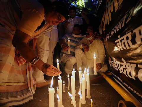Indian Youth Congress activists lighting candles during a march after a minor girl was allegedly raped and murdered, in New Delhi on Wednesday, August 4, 2021. 