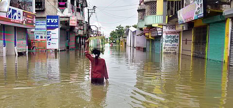 A woman carrying her belongings wades through a waterlogged road due to a flood triggered by heavy rainfall and water release from the Durgapur barrage, in Hooghly in West Bengal, on August 5.  Prime Minister Narendra Modi on Wednesday announced an ex-gratia of Rs200,000 each from the Prime Minister's National Relief Fund to the next of kin of those who lost their lives due to flooding in parts of West Bengal. Modi on Wednesday spoke to Madhya Pradesh Chief Minister Shivraj Singh Chouhan and Mamata Banerjee, the Chief Minister of West Bengal, over the flood situation in both the states, assuring all possible support from the Centre.