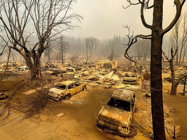 This photo shows cars and homes destroyed by the Dixie Fire line central Greenville, in Plumas County, California. 