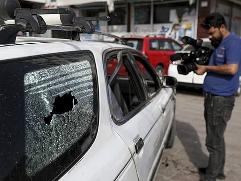 Afghan journalists films the vehicle in which director of Afghanistan's Government Information Media Center Dawa Khan Menapal was shot dead in Kabul, on August 6, 2021.  