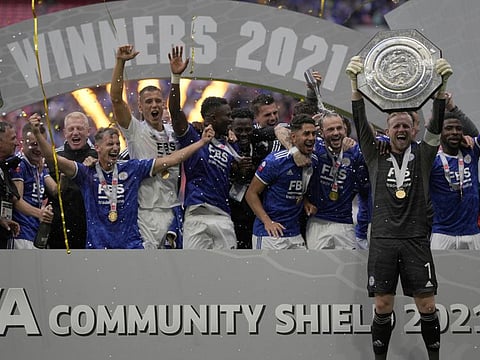 Leicester's goalkeeper Kasper Schmeichel lifts the trophy after winning the English FA Community Shield 1-0 against Man City at Wembley stadium, in London.