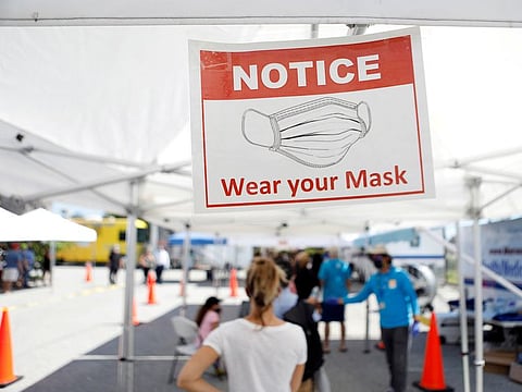 Patients wait in line to get a swab test at a COVID-19 mobile testing site hosted by the Manatee County Florida Department of Health in Palmetto, Florida.  