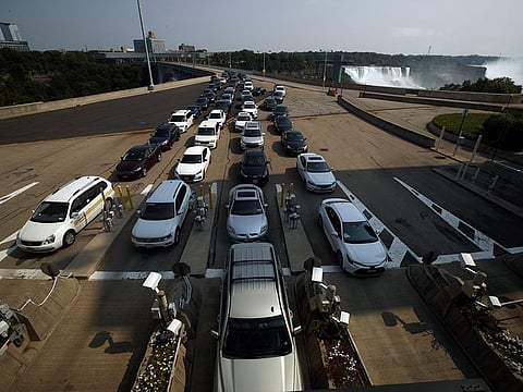 Drivers wait in line at the Canadian border crossing in Niagara Falls, Ontario, Canada, on Monday, Aug. 9, 2021.