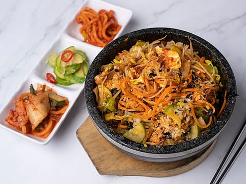 A step-by-step guide to making Korean bibimbap, a healthy assortment of rice, vegetables, minced beef and egg mixed in red chili pepper sauce.