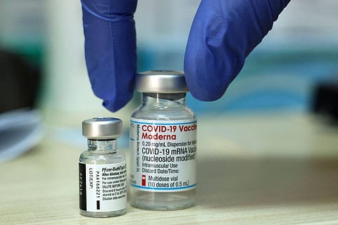 Pfizer-BioNTech and Moderna vaccine doses on a table before being administering at a Clalit Health Services Medical Centre in east Jerusalem on August 10.