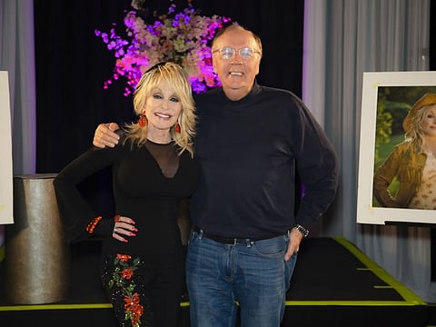 An undated photo provided by Dolly Parton, shows Parton with James Patterson. They teamed up on a novel about an aspiring country singer who goes to Nashville to seek her fortune and escape her past.