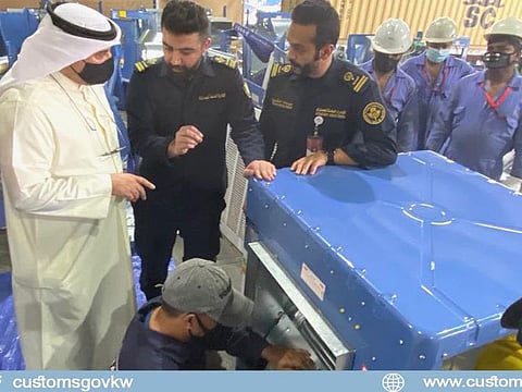 Kuwaiti customs officials check the seized drug haul. 