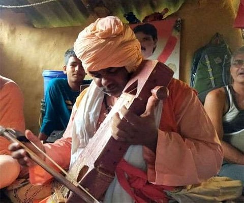 The man in turban playing violin at his wife’s home in Jharkhand.