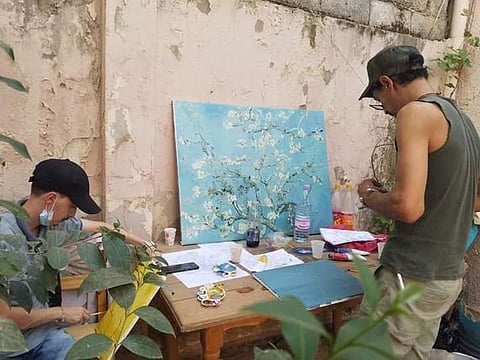 Artist and social activist Jamal bin Ismael (right) at work.
