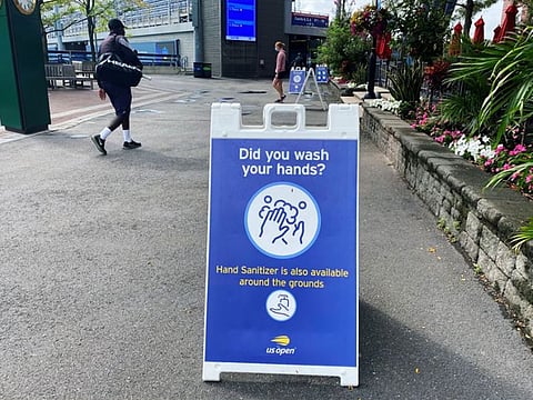 A sign reminding onlookers of proper health and safety protocols to prevent the spread of the coronavirus disease is seen inside the USTA Billie Jean King National Tennis Center ahead of the start of the U.S. Open tennis Grand Slam tournament, in the Queens borough of New York City.