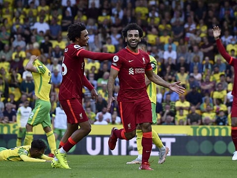 Liverpool's Mohamed Salah celebrates after scoring his side's third goal during the English Premier League match against Norwich City at Carrow Road in Norwich, England.