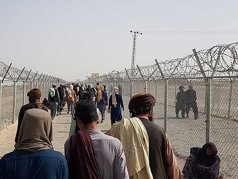 People arriving from Afghanistan make their way at the Friendship Gate crossing point at the Pakistan-Afghanistan border town of Chaman, Pakistan August 15, 2021. 