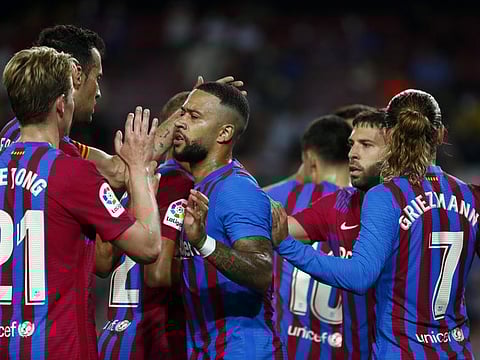 Barcelona players celebrate after scoring their third goal during a Spanish La Liga match against Real Sociedad at Camp Nou stadium in Barcelona, Spain