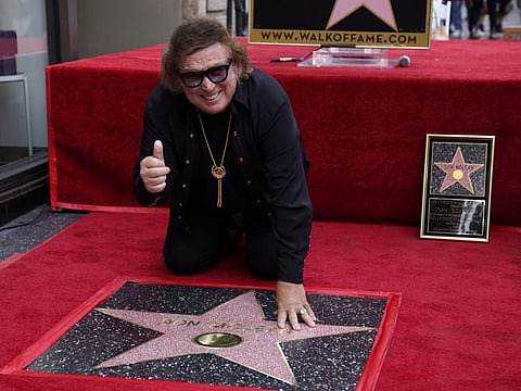 "American Pie" singer/songwriter Don McLean poses over his new star on the Hollywood Walk of Fame during a ceremony for him, Monday, Aug. 16, 2021, in Los Angeles.