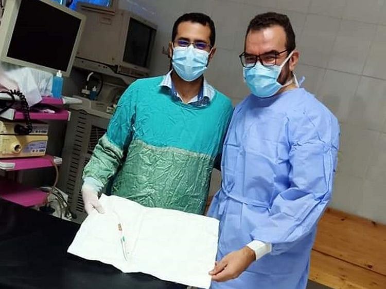 Medics show the tooth brush removed from women's esophagus in a Delta province.
