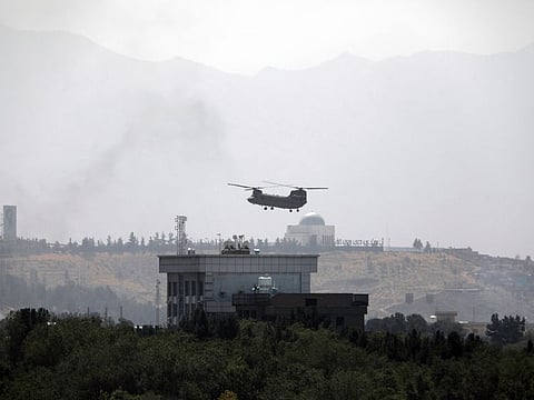 A US Chinook helicopter flies near the US Embassy in Kabul on Sunday