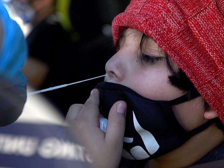 A young boy is tested for the COVID-19 