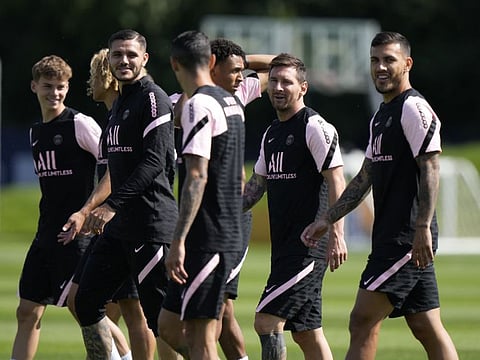 Lionel Messi, second right, walks on the pitch with teammates at the Paris Saint-Germain training camp in Saint-Germain-en-Laye, west of Paris. The 34-year-old Argentina star may not be involved in tonight's game against Brest.