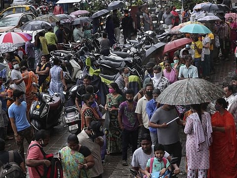 People wait to get inoculated against COVID-19 in Mumbai, on August 19, 2021. 