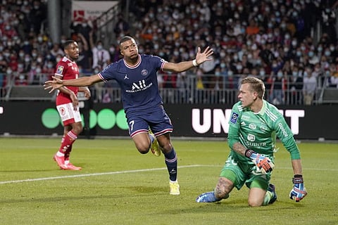 PSG's Kylian Mbappe, left, celebrates after scoring his side's second goal during a French League One soccer match between Brest and PSG at the Francis-Le Ble stadium in Brest, France.