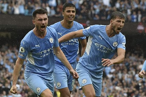 Manchester City's Aymeric Laporte, left, celebrates after scoring his side's third goal during the English Premier League match against Norwich City at Etihad stadium.