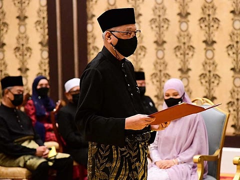 Malaysia's incoming Prime Minister Ismail Sabri Yaakob takes the oath of office during his swearing-in ceremony as the country's new leader at the National Palace in Kuala Lumpur on Saturday, Auguts 21, 2021. 
