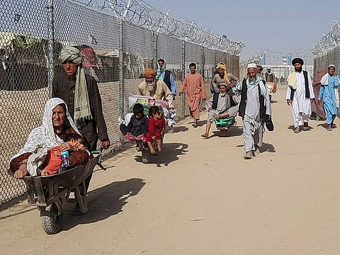 Afghan nationals arrive into Pakistan after crossing the Pakistan-Afghanistan border crossing point in Chaman on August 21, 2021, following the Taliban's stunning takeover of Afghanistan. 