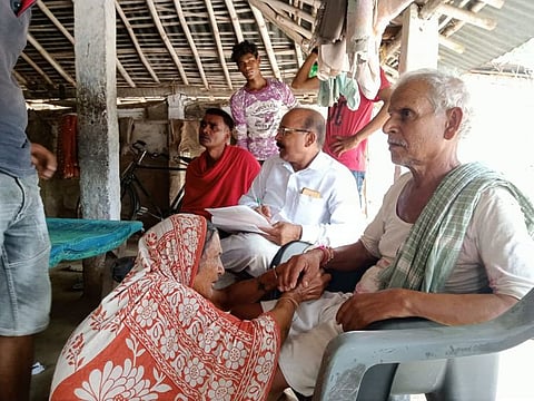 The woman tying safety band on the wrist of her brother in the presence of village court members.