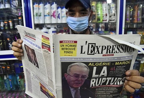 An Algeria man holds today's newspaper in the capital Algiers, on August 25, 2021. 