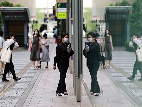 People  make their way at a shopping district in Tokyo, Japan, on August 25, 2021. 