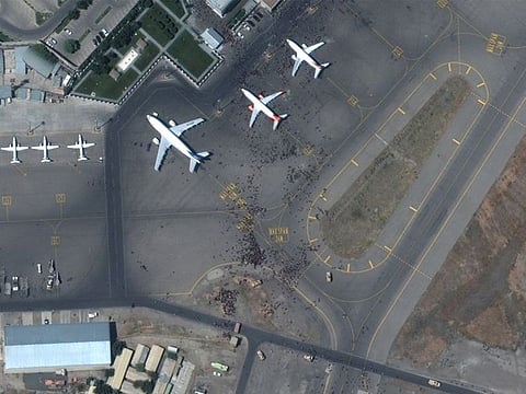 File image [August 27]: Crowds of people are seen on the tarmac at Kabul's airport in Afghanistan. 