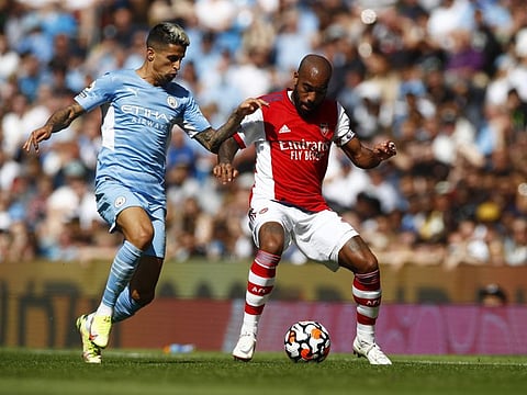 Manchester City's Joao Cancelo in action with Arsenal's Alexandre Lacazette. City cruised to a comfortable 5-0 win at the Etihad.