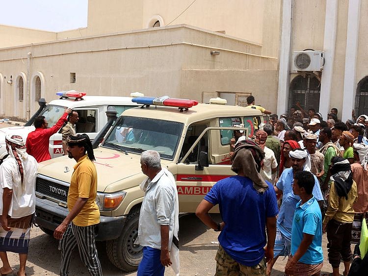 People gather as ambulances transport casualties of strikes on Al Anad air base to the Ibn Khaldun hospital in the government-held southern province of Lahij, on August 29, 2021.  