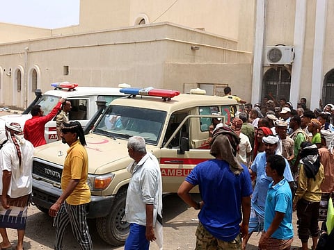 People gather as ambulances transport casualties of strikes on Al Anad air base to the Ibn Khaldun hospital in the government-held southern province of Lahij, on August 29, 2021.  