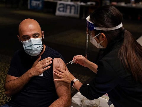 Nurse immuniser Kelie Lee administers the AstraZeneca vaccine to a patient at a coronavirus disease (COVID-19) vaccination clinic at the Bankstown Sports Club during a lockdown to curb an outbreak of cases in Sydney, Australia, August 25, 2021.