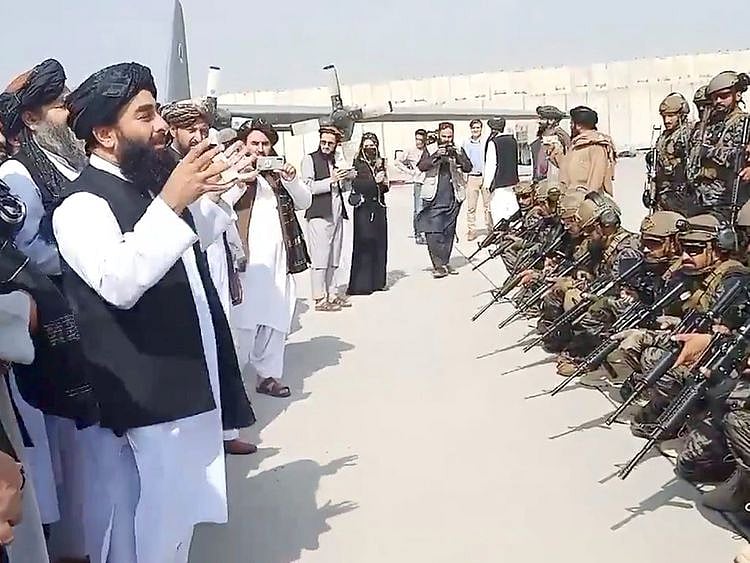  Taliban spokesman Zabihullah Mujahid speaks to Badri 313 military unit at Kabul's airport on August 31, 2021 in this still image obtained from a handout video.  