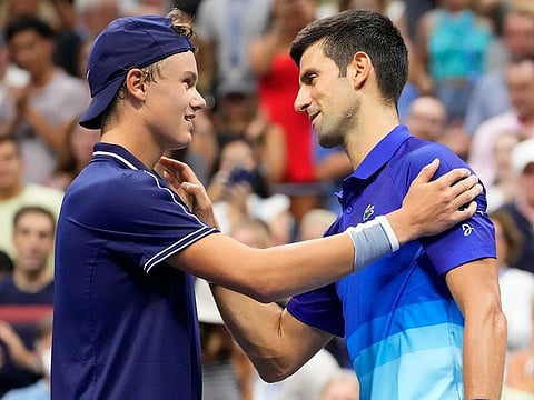 Novak Djokovic of Serbia, right, after beating Holger Vitus Nodskov Rune of Denmark on day two of the 2021 U.S. Open tennis tournament at Billie Jean King National Tennis Centre in New York.