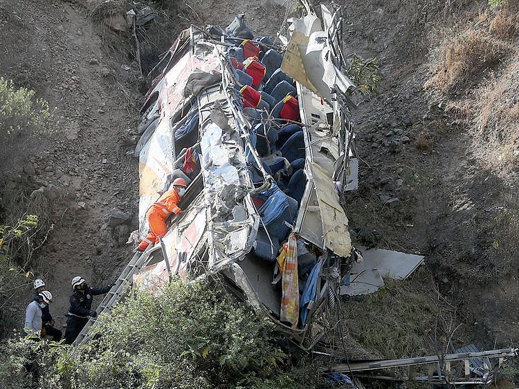 Rescue workers check a bus after it crashed, in Matucana, Peru, on August 31, 2021. 